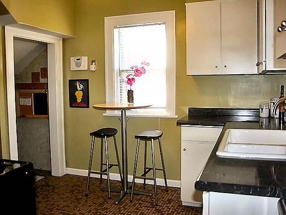 Bright kitchen with stainless steel appliances and eat-in area