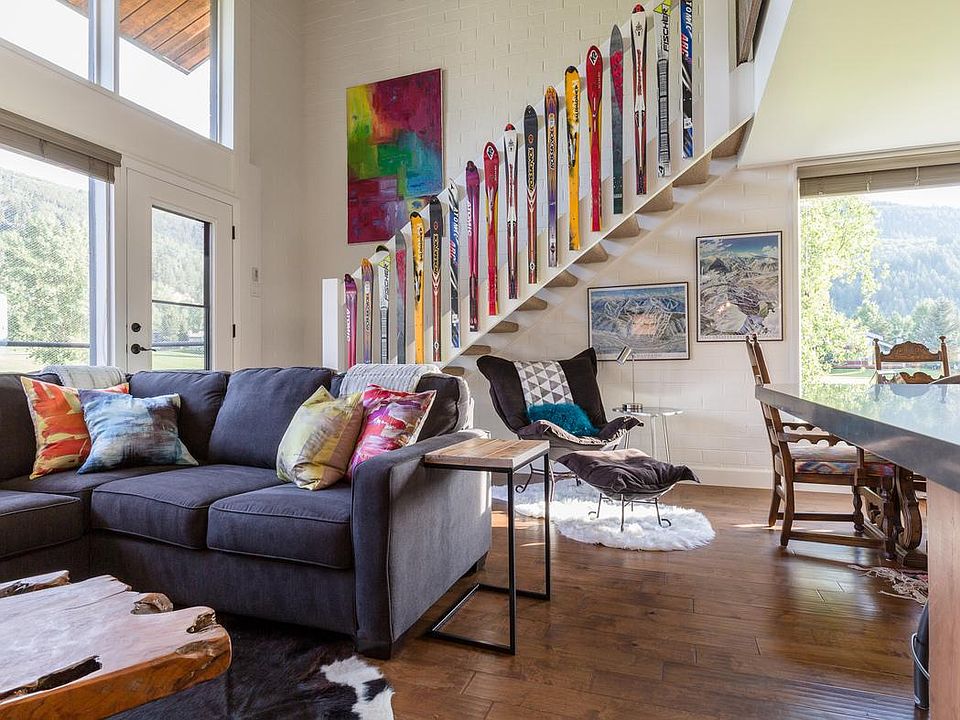 Sitting area under the stairs to master, door to balcony, windows allow light to flood the space!