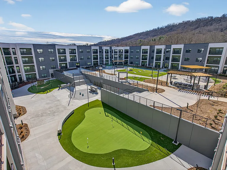 Enjoy evenings by the fire pits, friendly competition on the putting green, lawn games and chess, or unwind in Adirondack chairs and hammocks beneath the open sky.