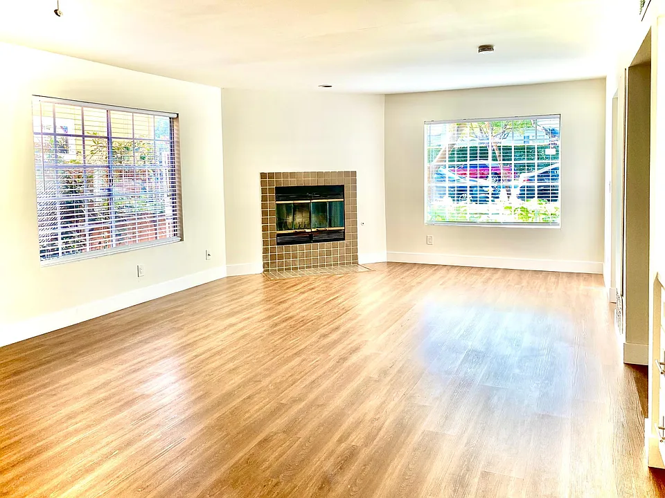 complete renovated. spacious living room with fire place & wood floor through out