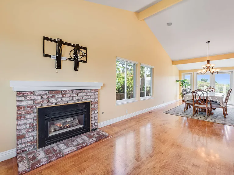 Living room with gas fireplace and dining room
