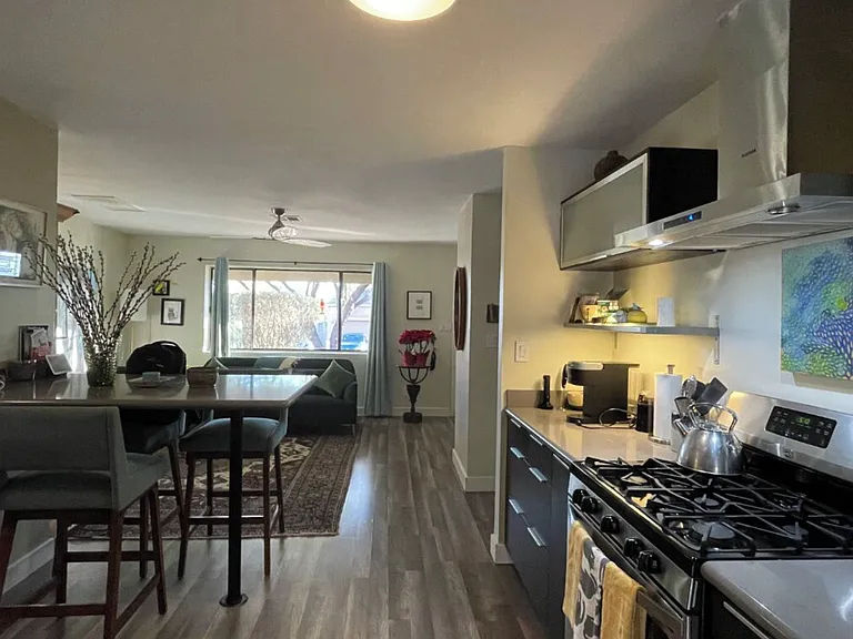 Kitchen looking toward living room with side view of Corian counter table