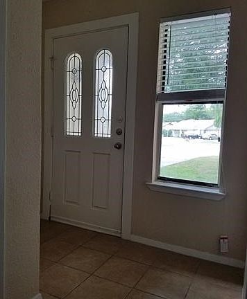 Nice entry shows off the glass paneled door and lets in natu