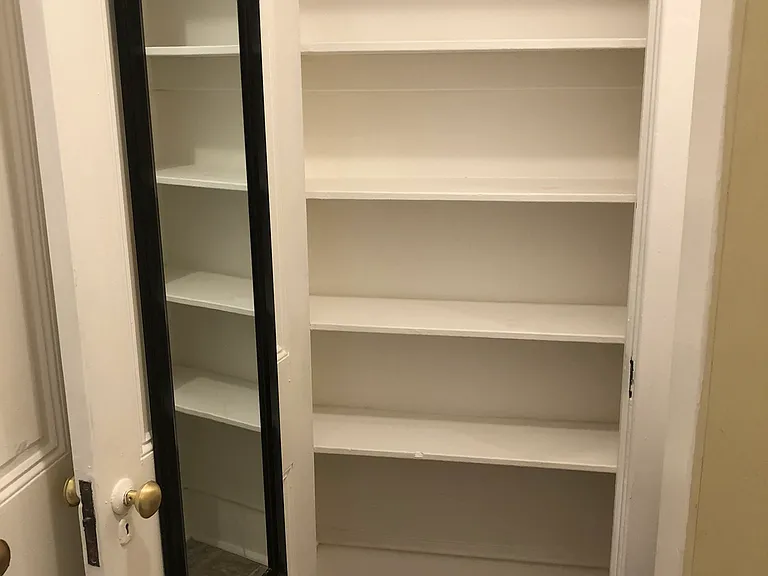 storage closet with full length mirror