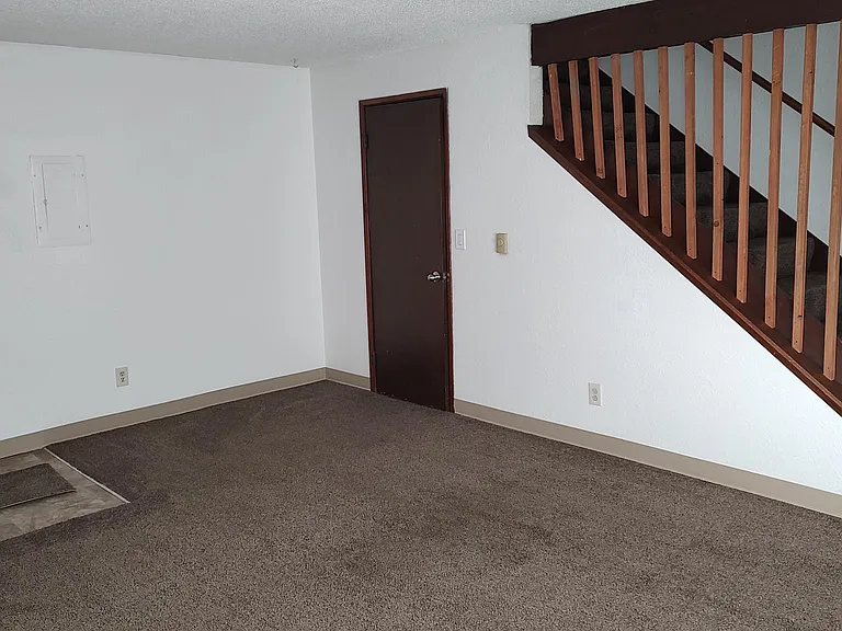 Living room area, closet and stairs to the upstairs bedrooms and bathroom.