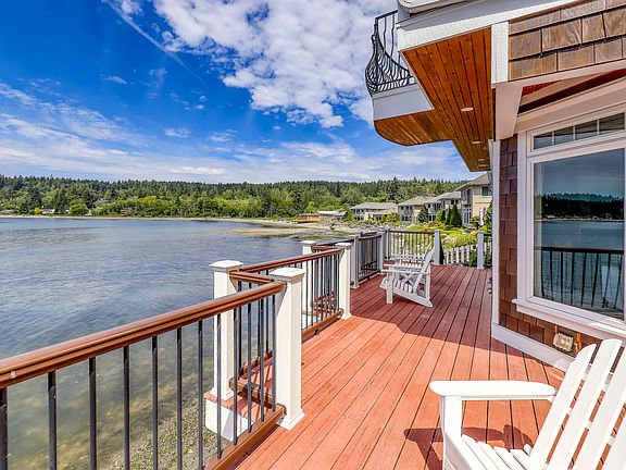 Enormous wraparound deck with multiple private sitting, dining, and entertaining areas.