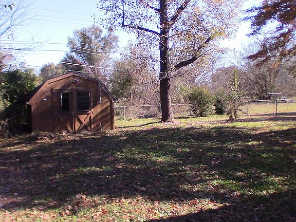 Backyard view from house to back of yard, including shed. Notice large back yard and no house close in back. All fenced