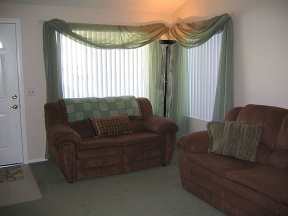 The living room has cathedral ceilings & dual pane windows for lots of light.