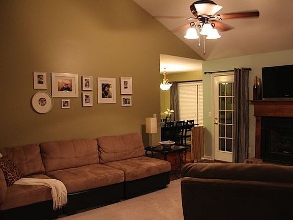 Living Room has vaulted ceiling, new paint, new ceiling fan, new hardwood floo