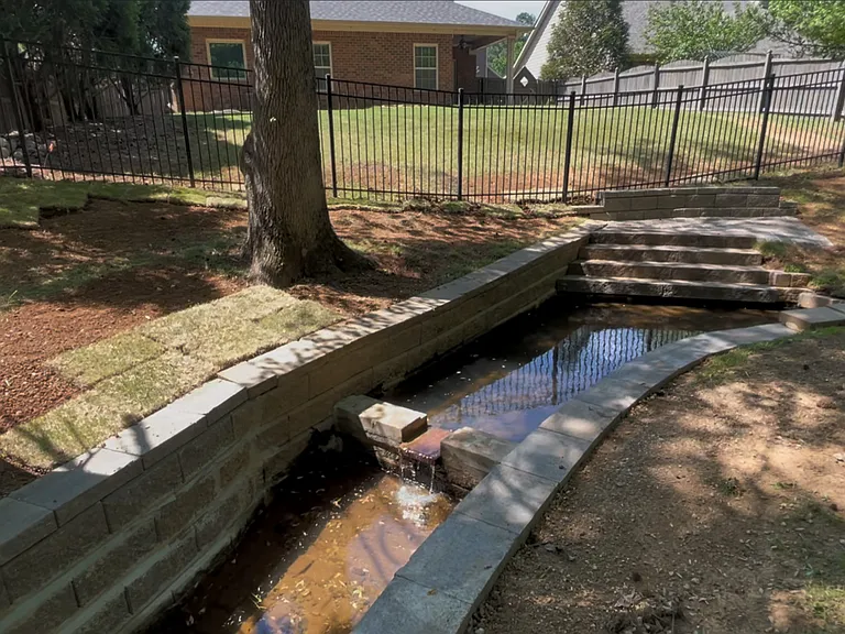 Creek, patio, and waterfall