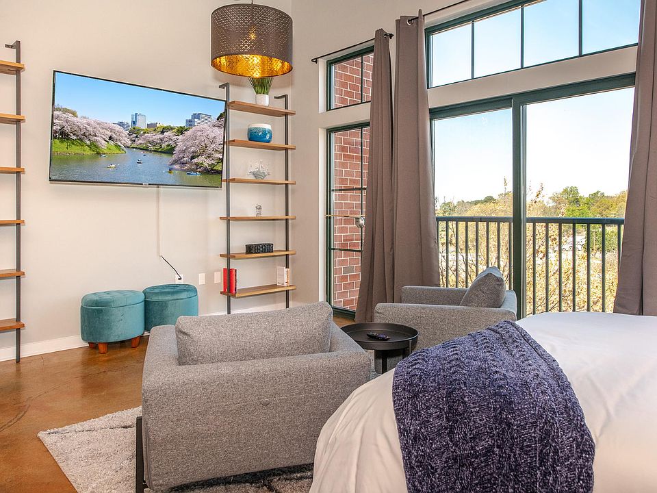 Seating area with 2 lounge chairs and additional stools for guests.