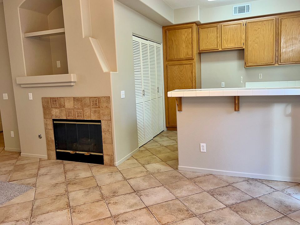 Fireplace in living room, laundry closet in kitchen