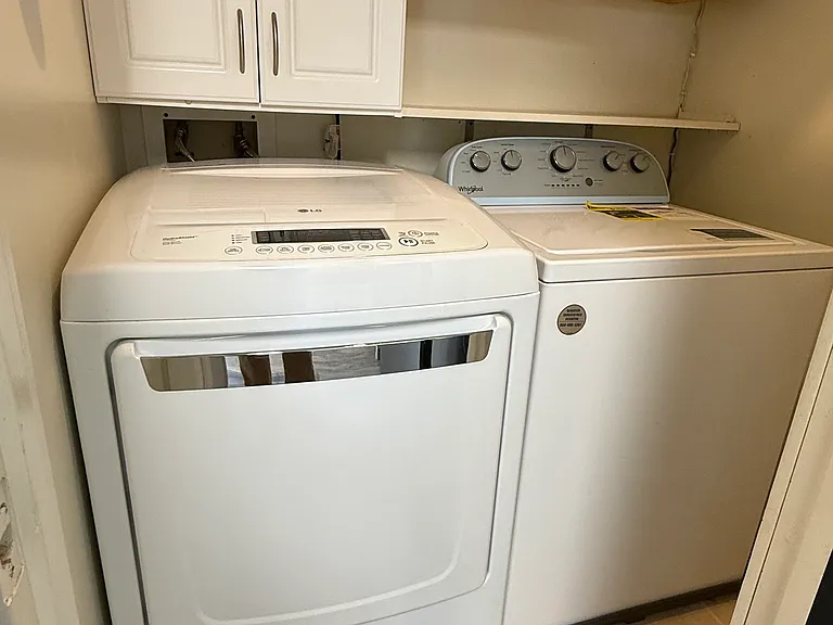 Hidden behind frosted glass & metal barn door: Laundry and cleaning storage room.