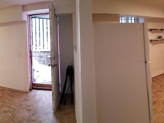 Open floor plan (L to R): Livingroom, front door, kitchen, bath at end of hall