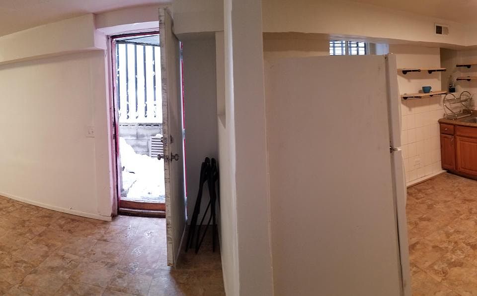 Open floor plan (L to R): Livingroom, front door, kitchen, bath at end of hall