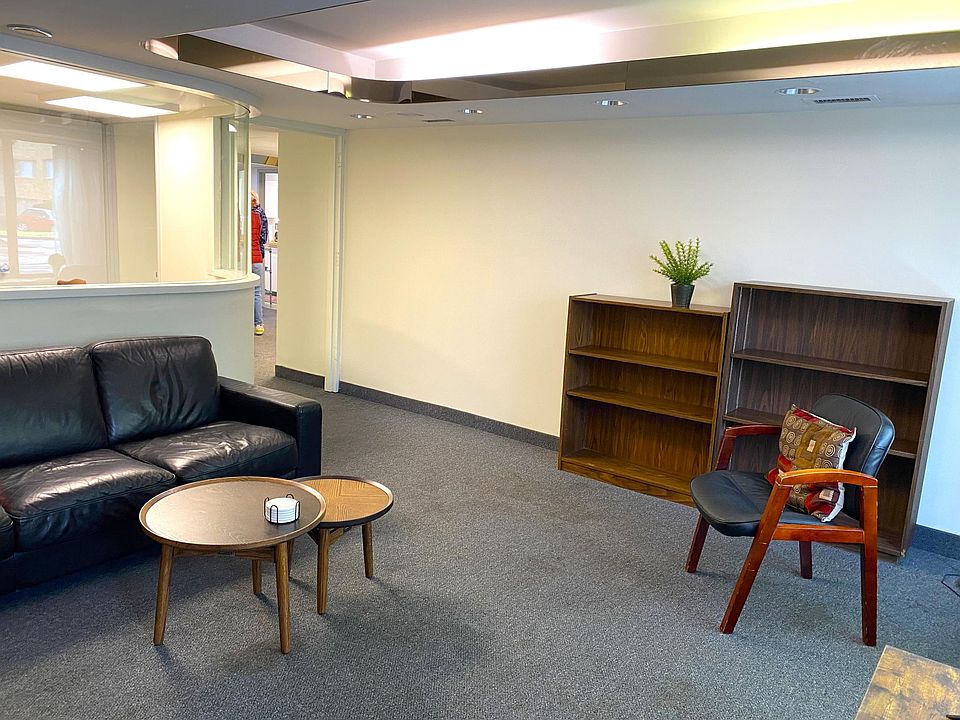 Large livingroom with seating and bookshelves.