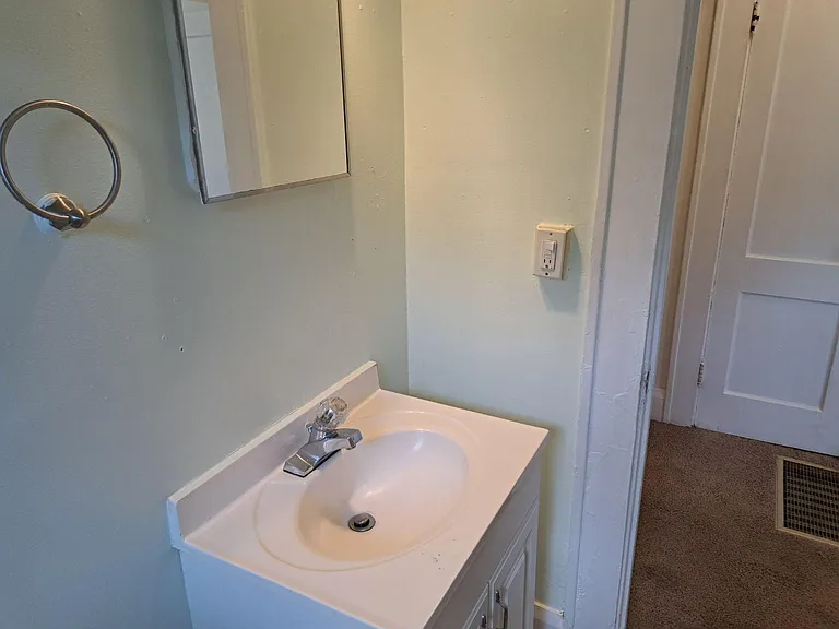 bathroom with partial view of the hallway