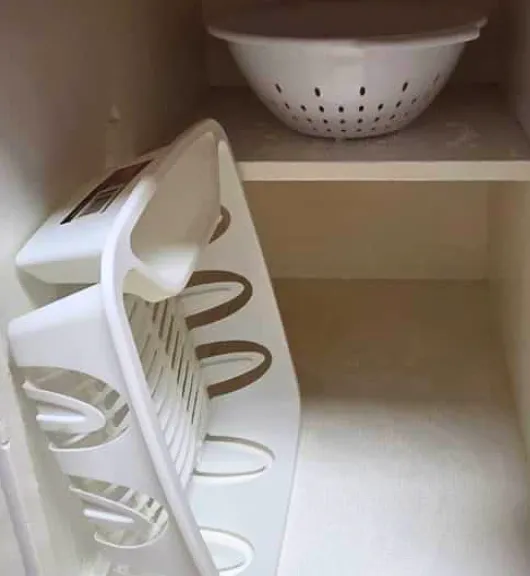 Kitchen equipped with dish and food draining essentials.