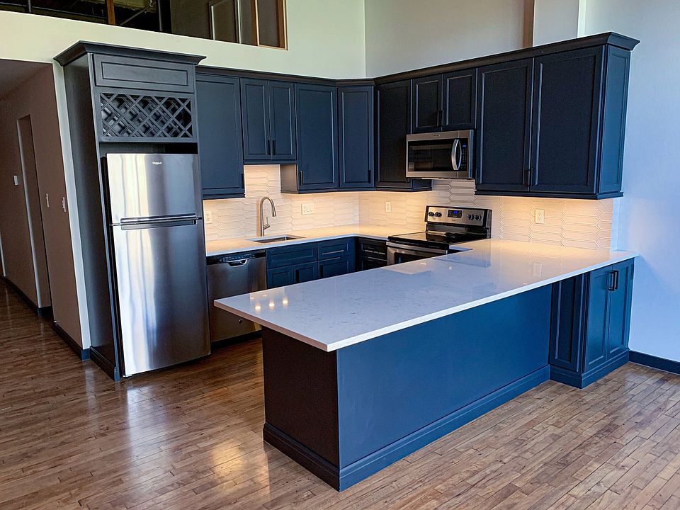 New Chef's Kitchen with Quartz Counters, large island with seating for 4, ceramic tile backsplash, stainless appliances, deep stainless sink, garbage disposal, and ample storage