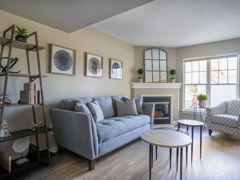 Interior view of living area of great room with corner fireplace & plank flooring