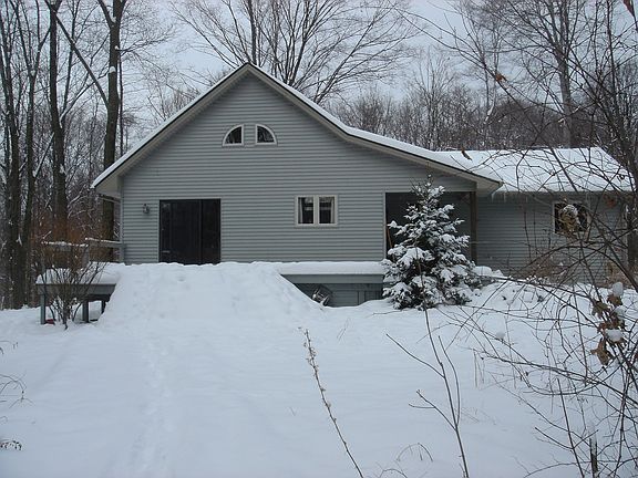Front view located on 6.88 acres of serenity, with city water and sewers