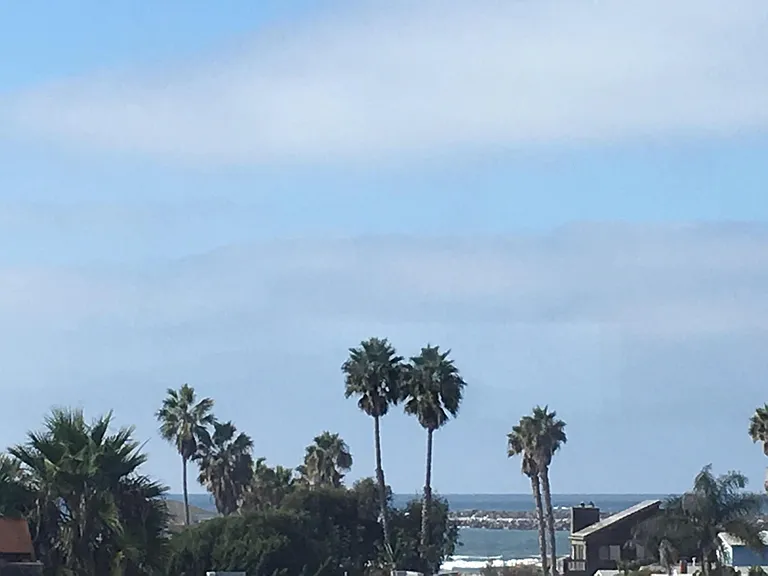 ocean views of waves, surfers, breakwater