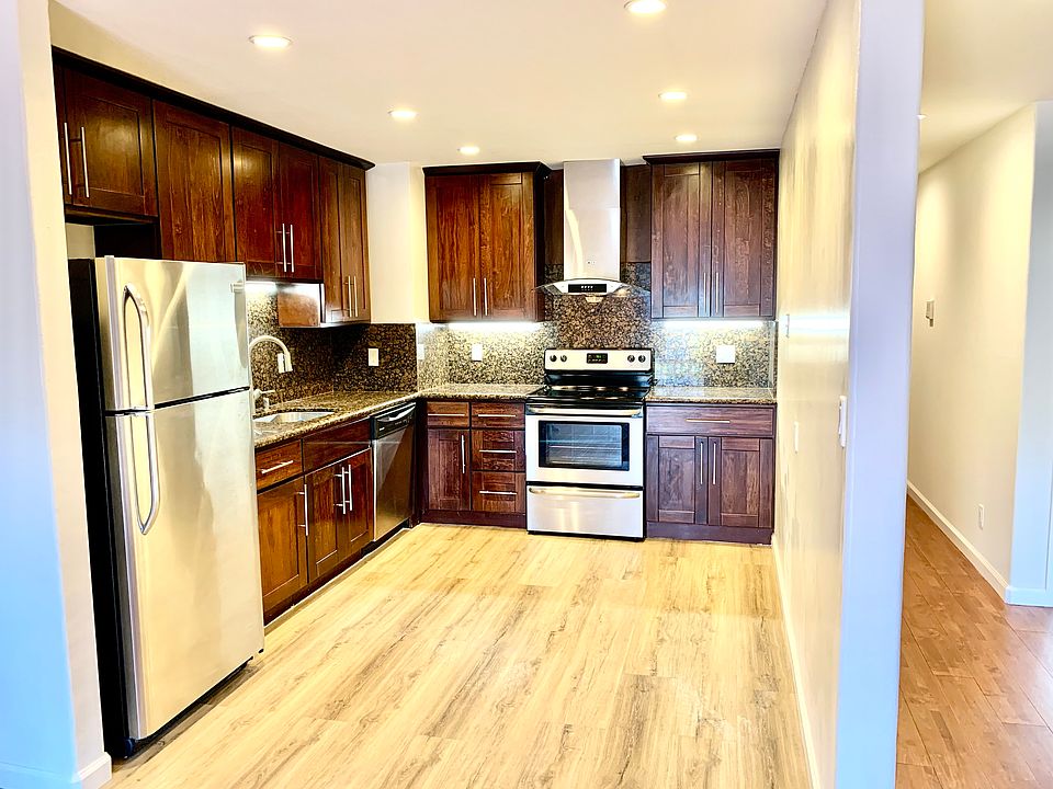 Updated kitchen with electric stove, dishwasher, and stainless steel refrigerator