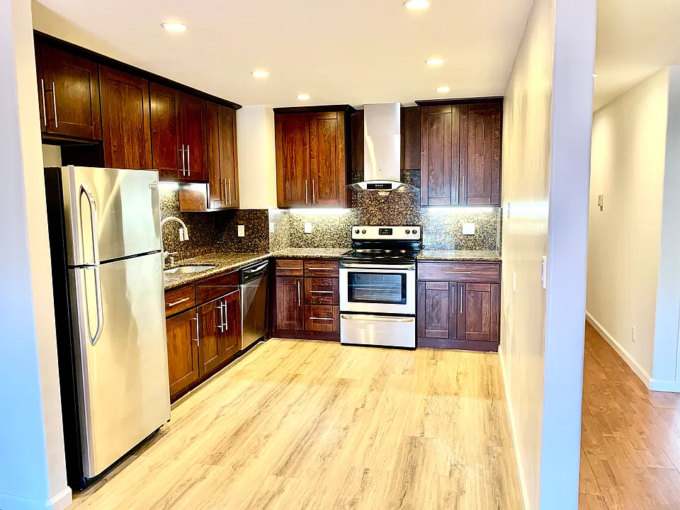 Updated kitchen with electric stove, dishwasher, and stainless steel refrigerator