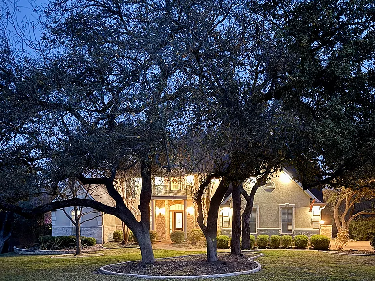 evening shot of front with yard