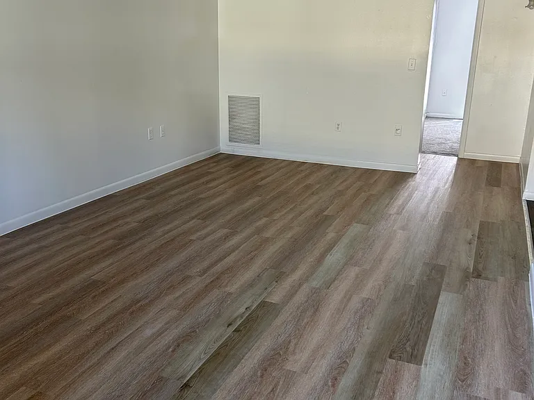 X-Large living room with beautiful planking floors.