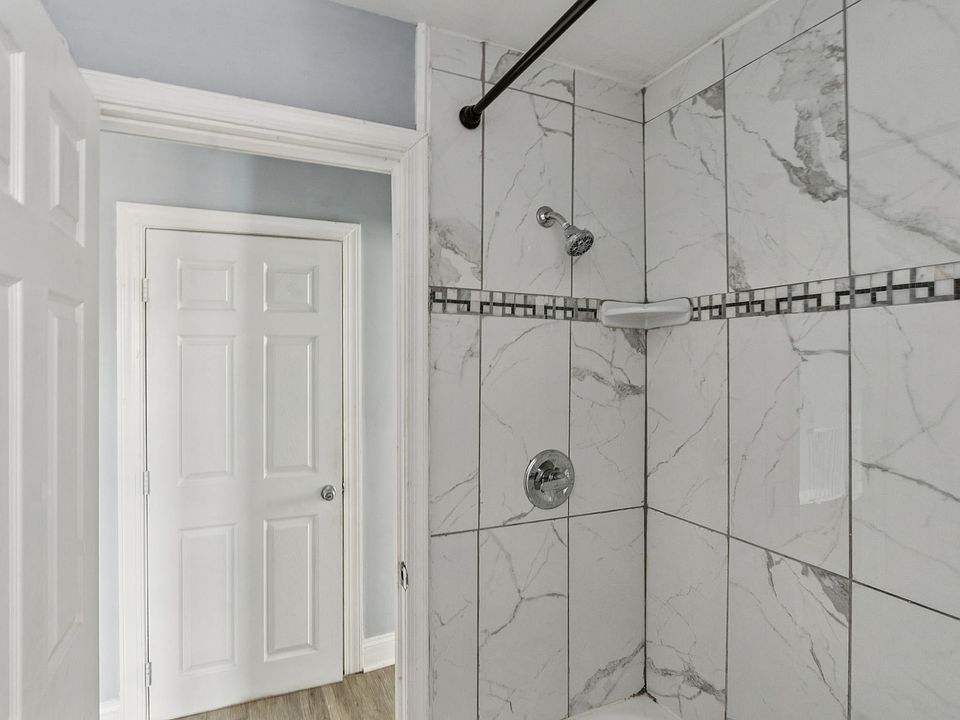 Full bathroom with tiled tub surround