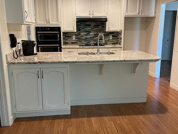 Updated kitchen with new granite counters and backsplash.