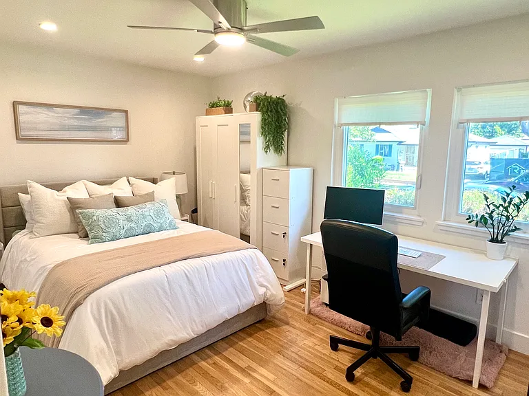 Guest Bedroom: Queen bed with dedicated workspace and Samsung monitor