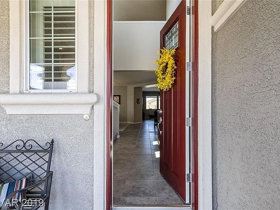 Beautiful leaded-glass entry door, and plantation shutters welcome you home