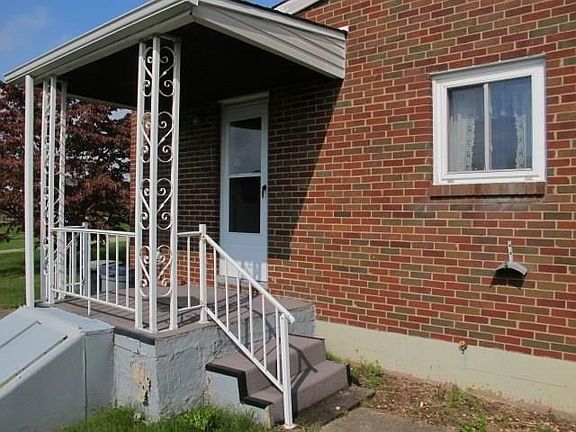 Covered side porch and man door to the basement
