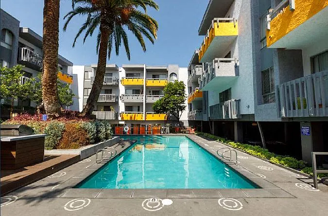Swimming Pool Surrounded by Palm Trees and with BBQ Pits
