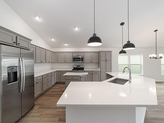Large Kitchen with ample cabinets and C shaped counter top