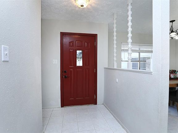 Bright entryway with retro light fixture