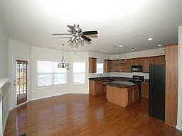 Kitchen with hardwood floors, granite countertops, cherry cabinets