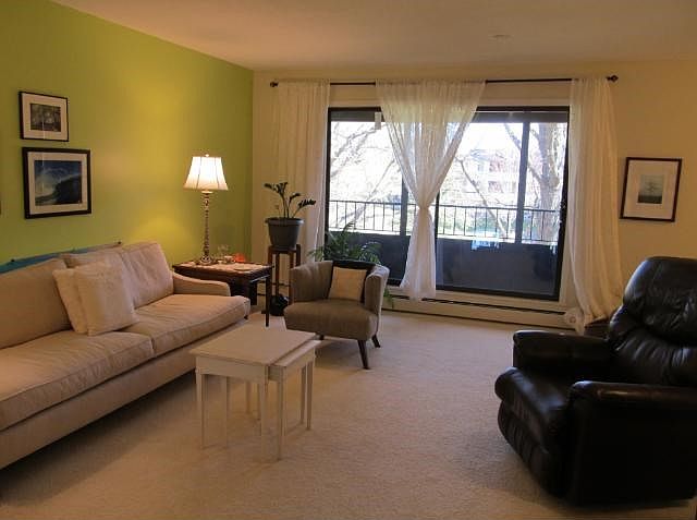 END UNIT! Living room area..please exclude the curtains but rod stays.