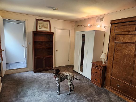 Murphy bed on the right, and closed for hanging clothes and western wall with bookshelf
