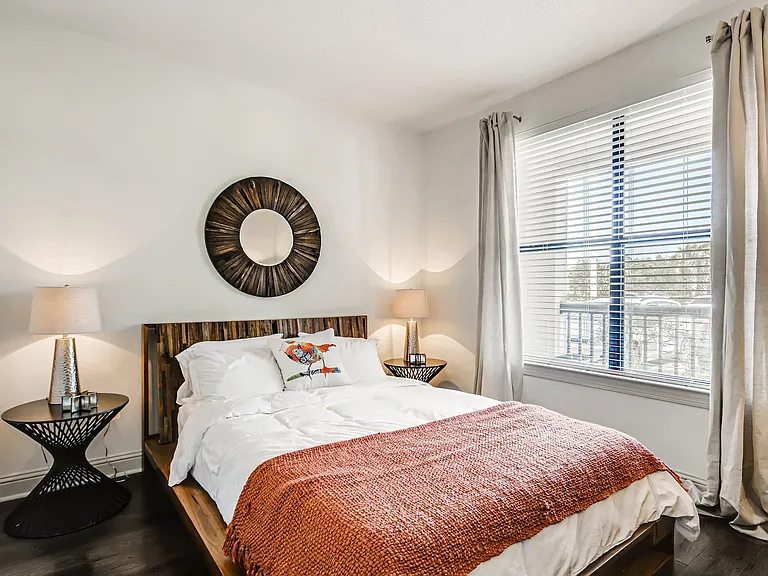 Bedroom with wood-designed flooring and window