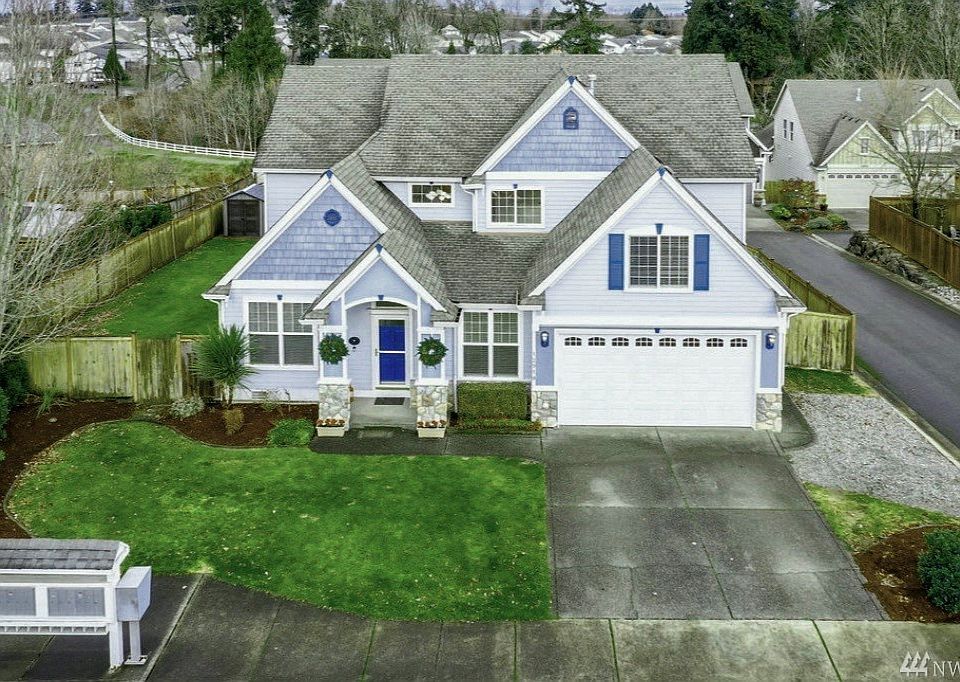 Craftsman Traditional home with 5 bedrooms + Den/office + bonus room + formal living and dining room + kitchen with island and eating space + cozy family room with gas fireplace + deep 3 car tandem garage w/loft storage + large shop area 