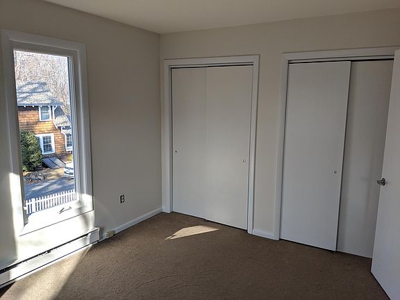 Second bedroom has two large closets and multiple windows.