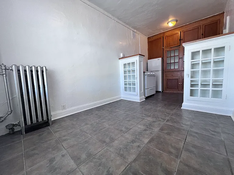 Enjoy your morning coffee in the kitchen's quaint dinette area, surrounded by beautiful built-in cabinetry that blends character with functionality.