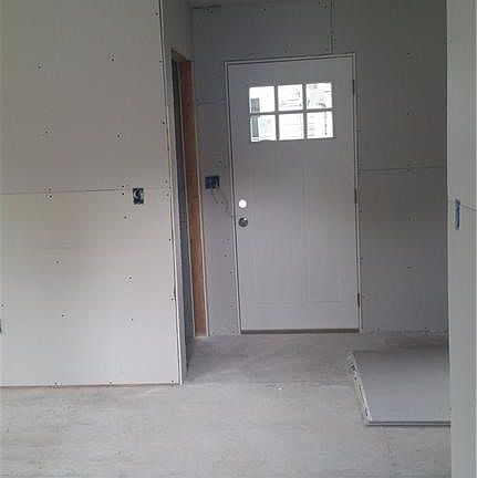 Front entrance.  To the left is the laundry area and half bath.  To the right is a large closet.  Ceramic tile will be laid in the front entryway.  Hardwood floors throughout the rest of the first floor.