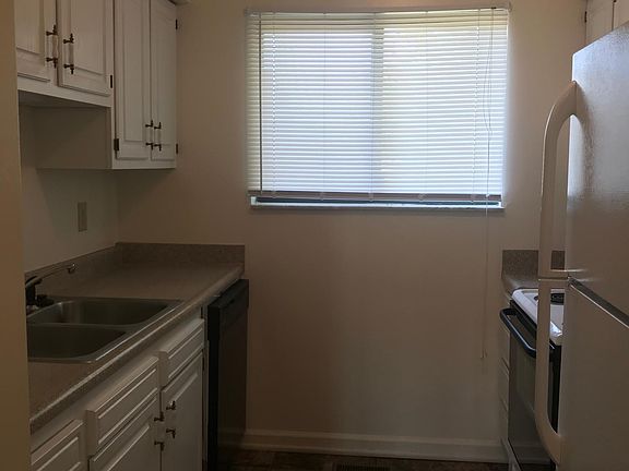 Kitchen with updated countertops and easy care appliances. Also notice the dishwasher!
