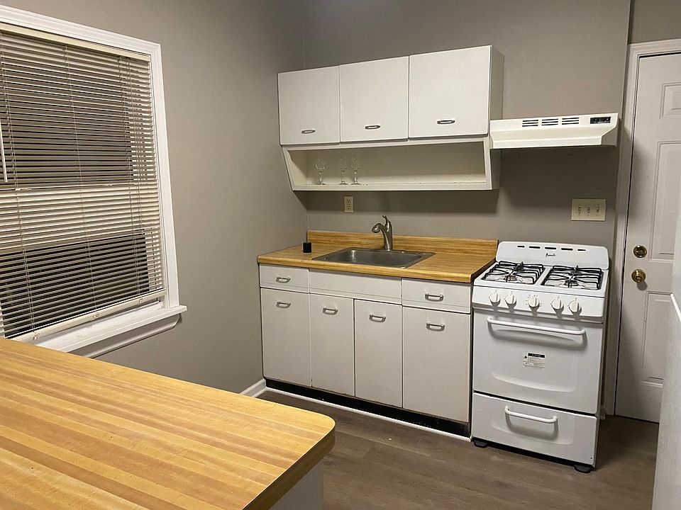 Stove and refrigerator plus exhaust fan.
