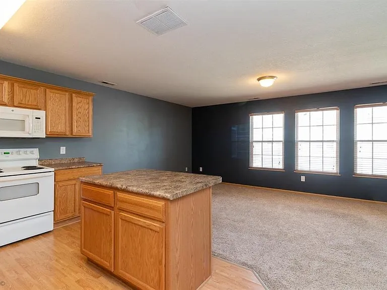 Kitchen to living room w/o furniture - open floor plan.