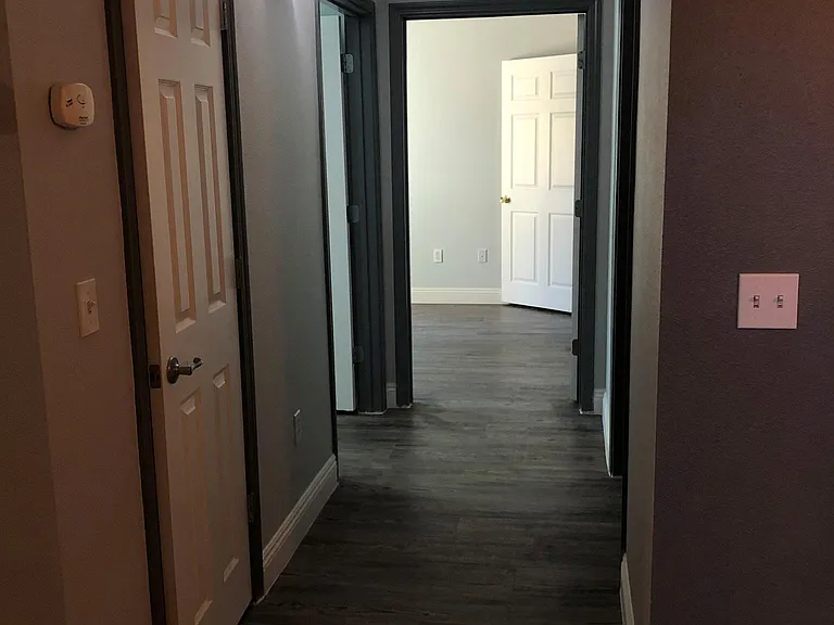 View of the hallway of room #2, room #3 and guest restroom.